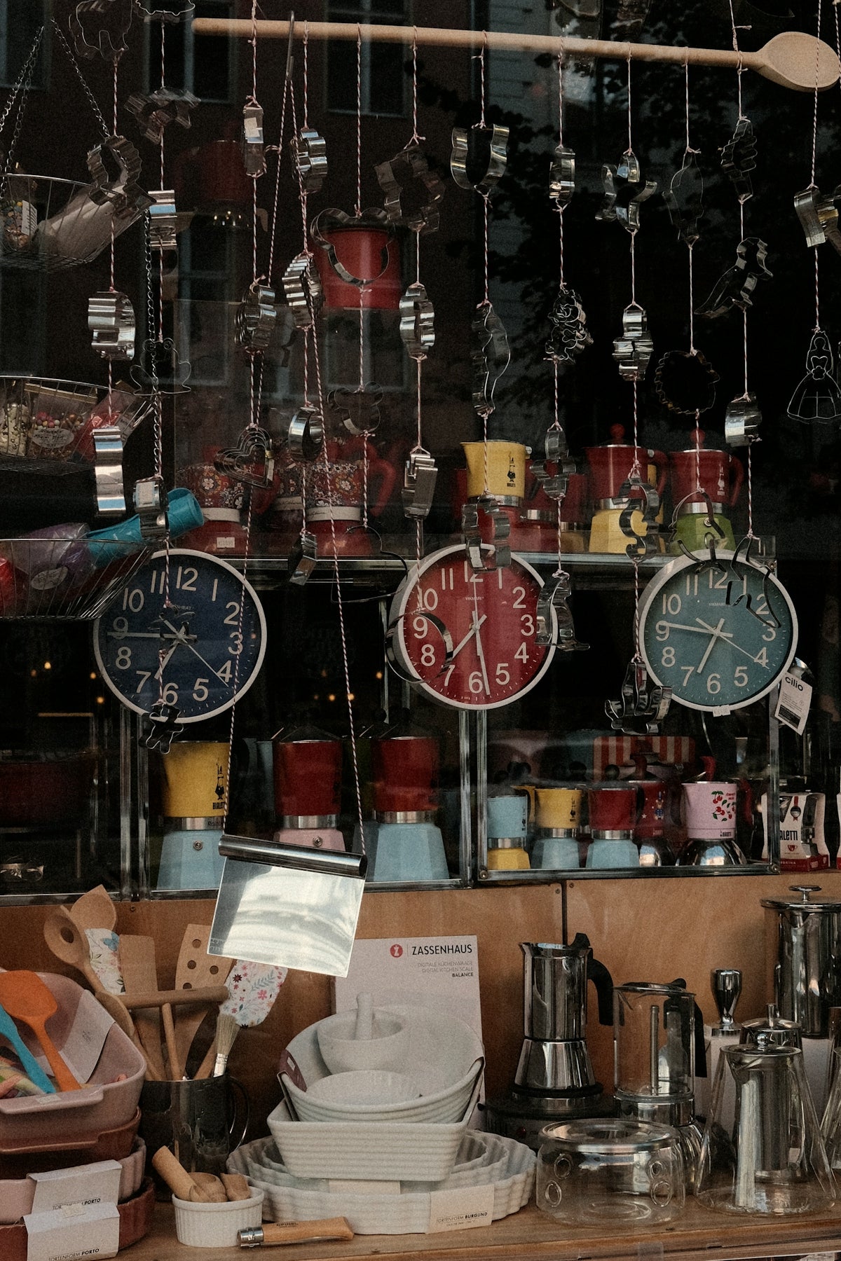 Shop display with colorful clocks, coffee makers, and kitchen utensils